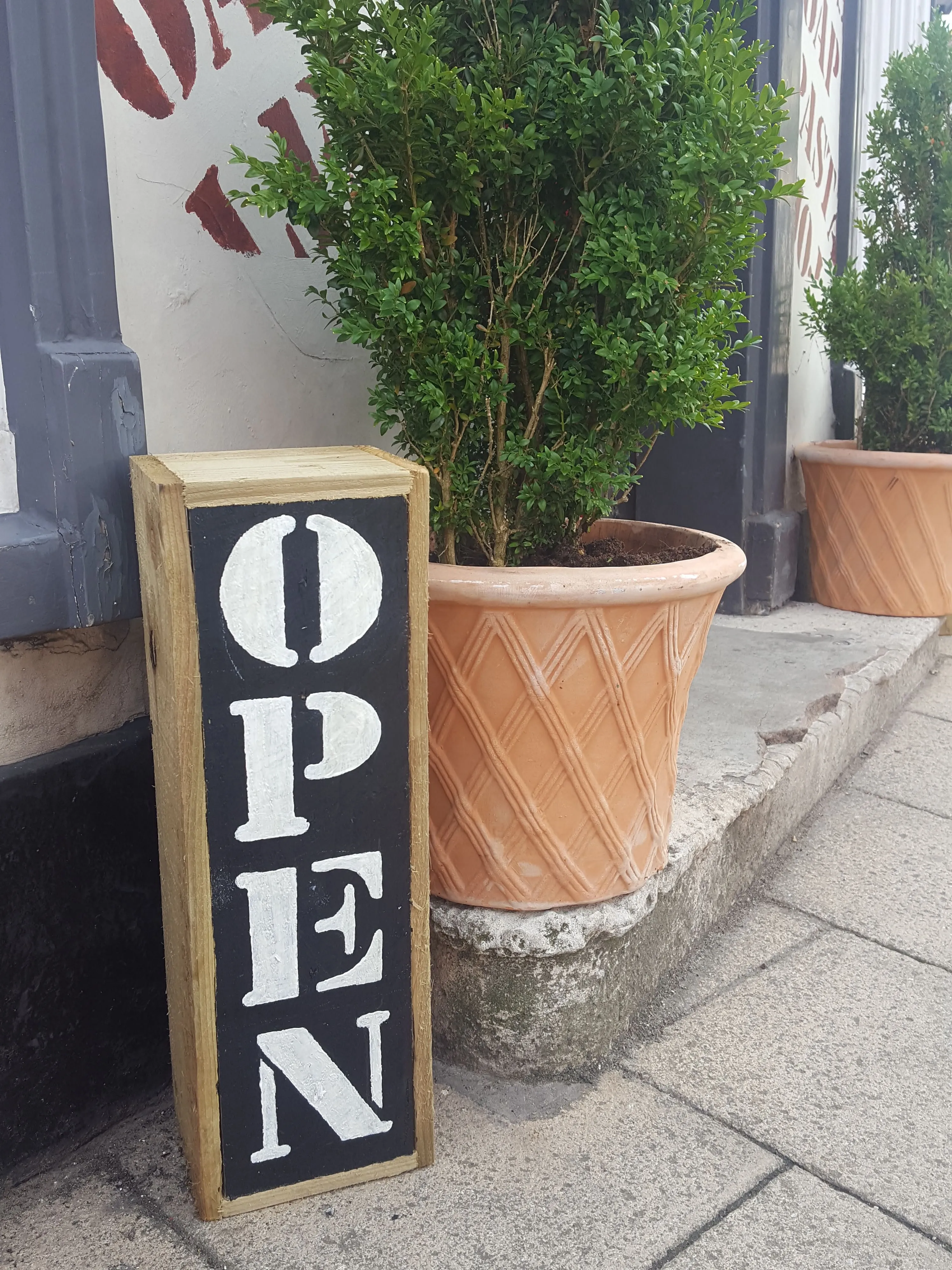 The stencilled OPEN sign outside the shop